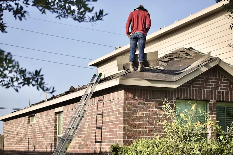 Professional roofer working on a residential roof in Armstrong